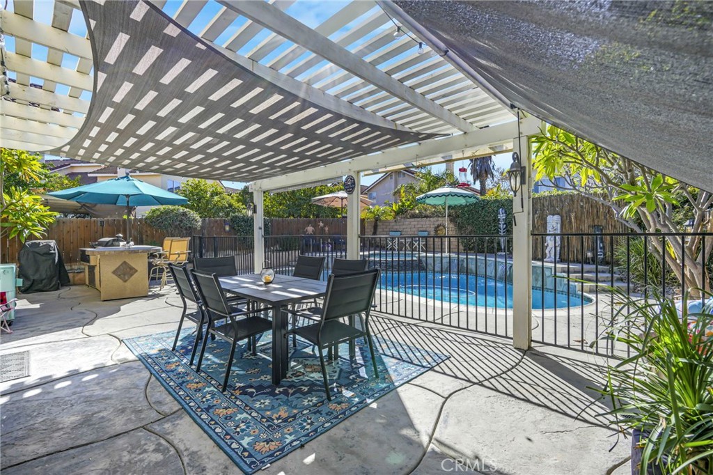 3670 Windstorm Way Riverside, CA 92503 - Photo 27 of 43 a view of a patio with a table chairs and a small yard