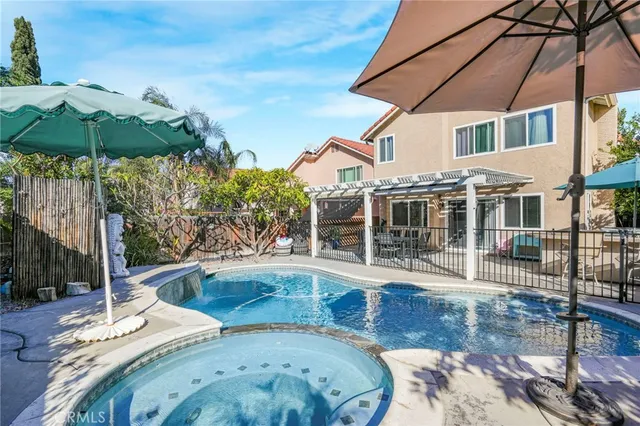a view of a house with backyard and sitting area