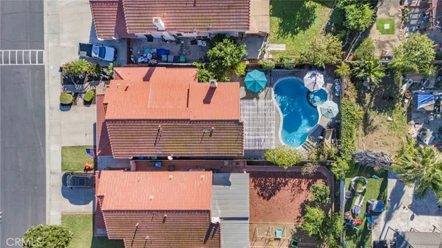 aerial view of a house with a yard and potted plants