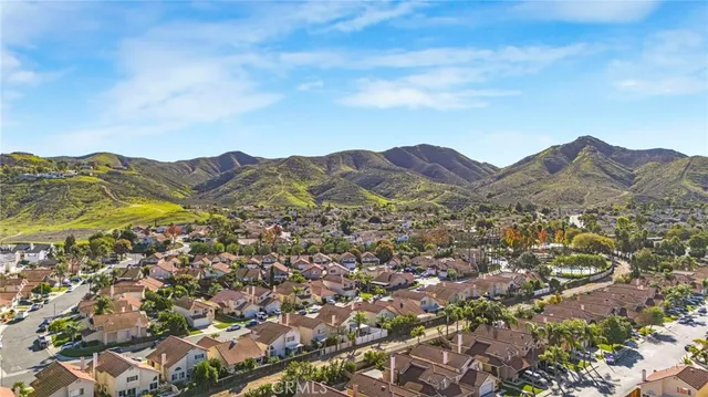 an aerial view of houses covered in trees