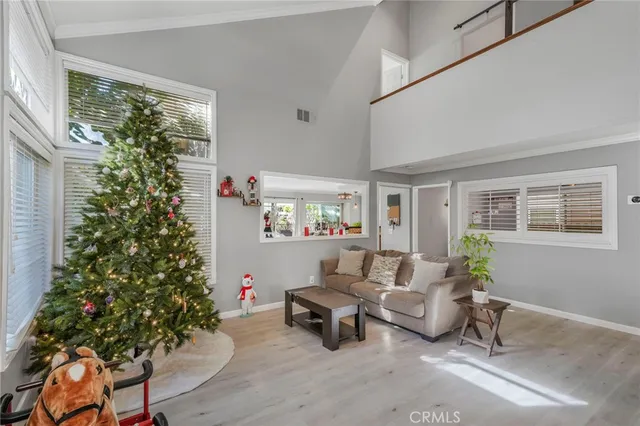 a living room with furniture and a potted plant