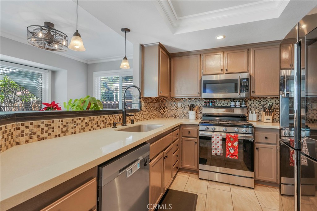3670 Windstorm Way Riverside, CA 92503 - Photo 6 of 43 a kitchen with stainless steel appliances a sink and a refrigerator