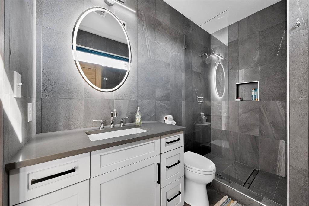 8839 Southern Shore Kemp, TX 75143 - Photo 21 of 40 a bathroom with a toilet sink vanity granite and a mirror