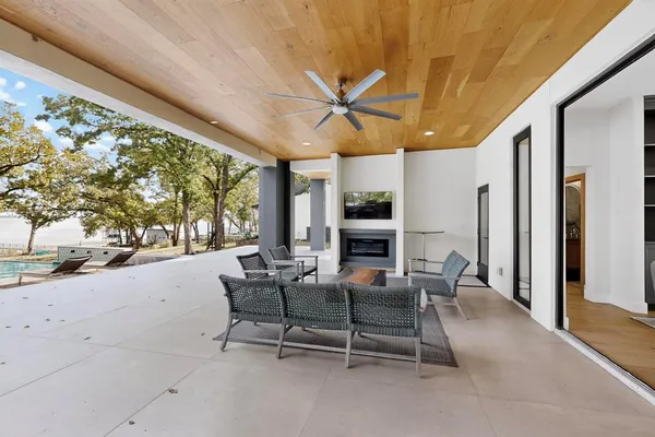 a view of a patio with a table and chairs and floor to ceiling window