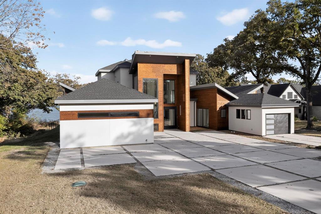 8839 Southern Shore Kemp, TX 75143 - Photo 3 of 40 a white house with a tree in front of it