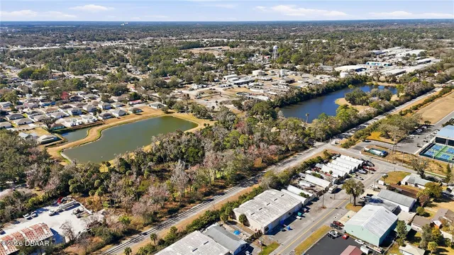 an aerial view of residential building and lake