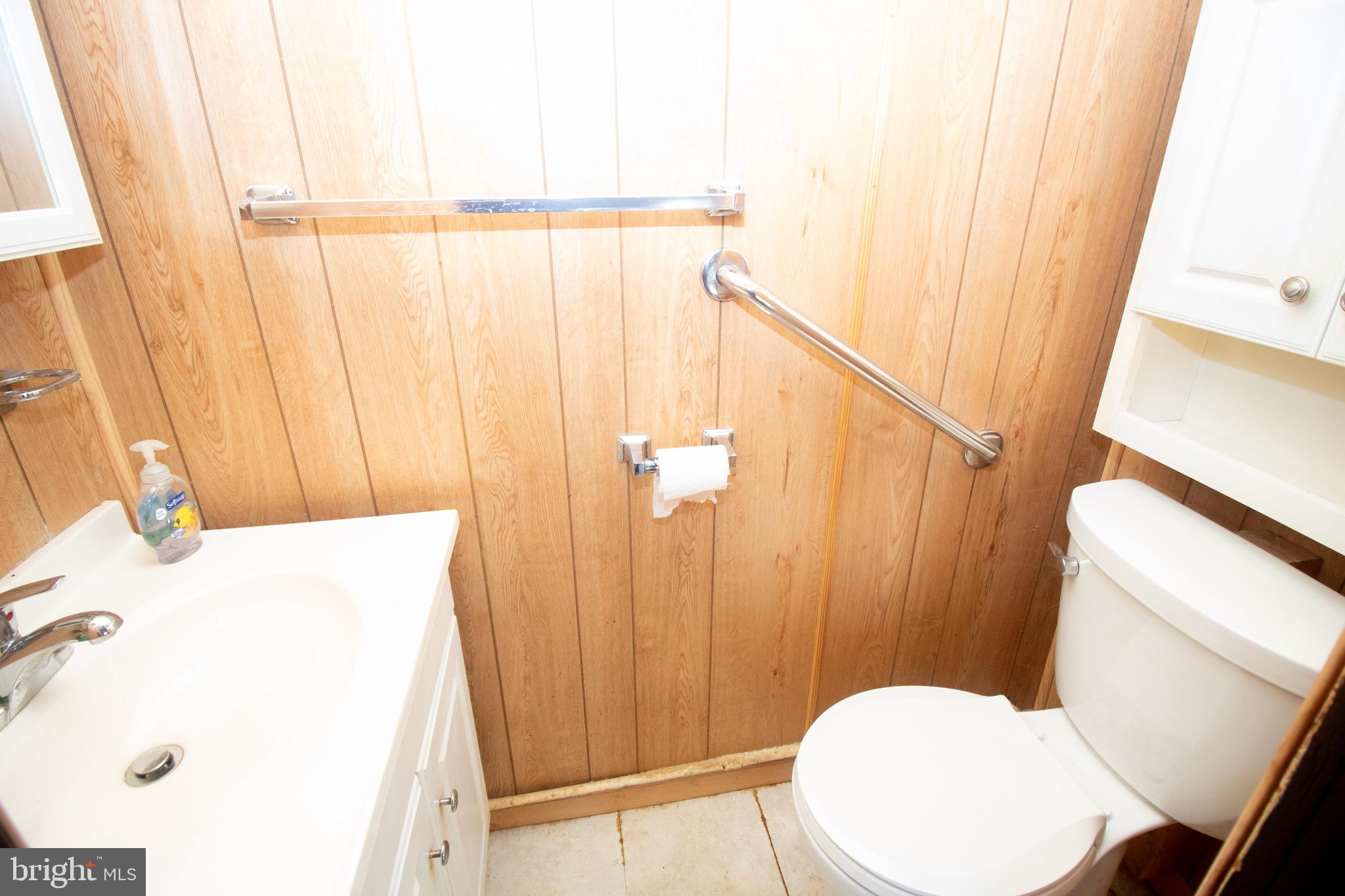 178 Mill Street Mount Holly, NJ 08060 - Photo 12 of 35 a bathroom with a sink a toilet and shower curtain