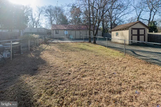 a view of a backyard with large trees