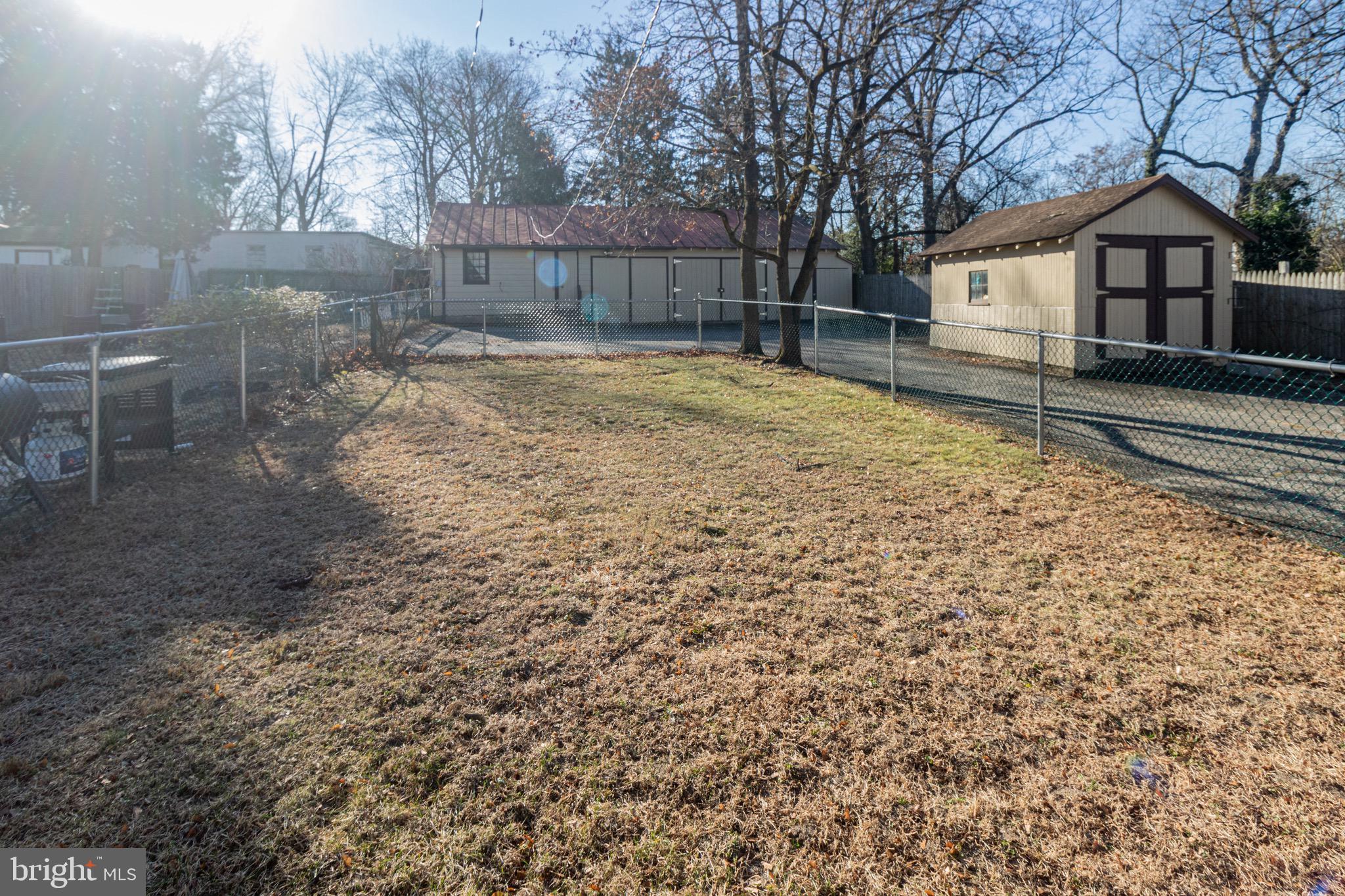 178 Mill Street Mount Holly, NJ 08060 - Photo 27 of 35 a backyard of a house with large trees and wooden fence