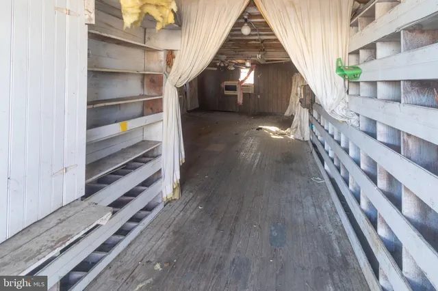 a view of a room with wooden floors