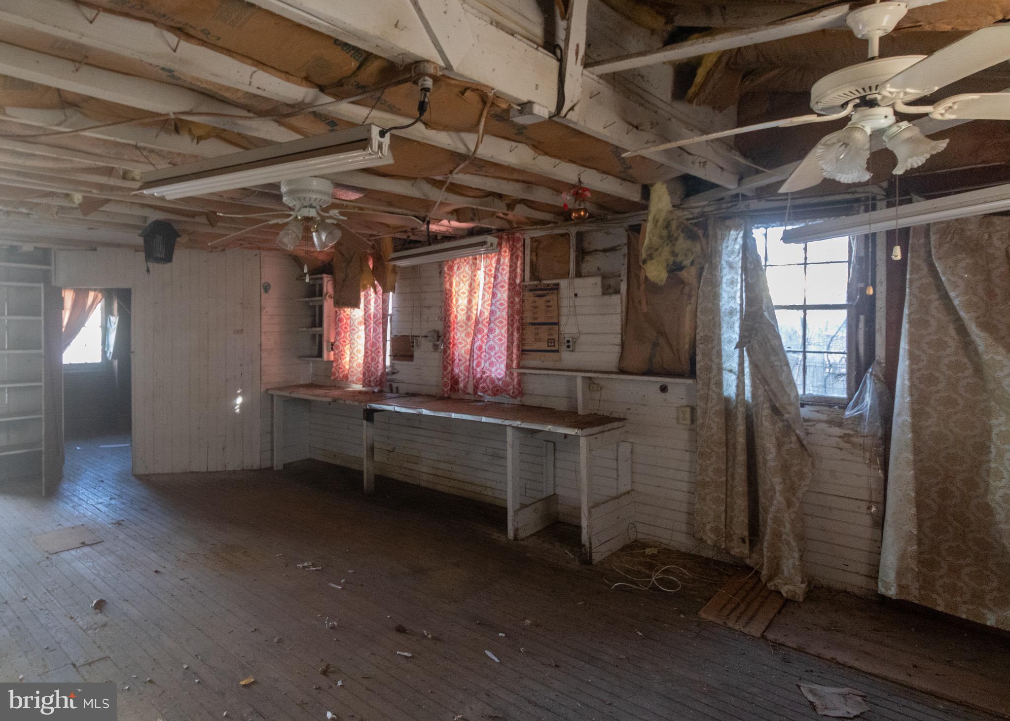 178 Mill Street Mount Holly, NJ 08060 - Photo 34 of 35 an empty room with wooden floor and windows