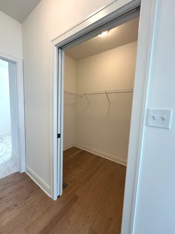 an empty room with wooden floor and door