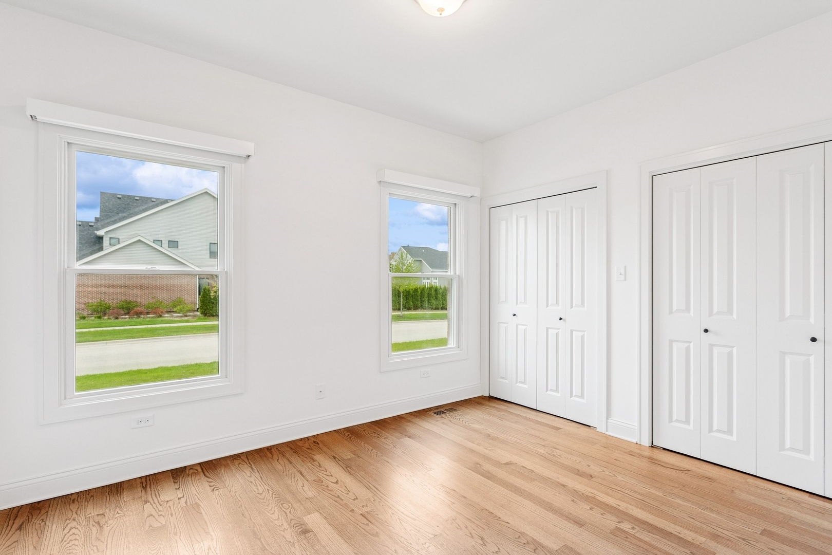 9014 Gloucester Road Woodridge, IL 60517 - Photo 18 of 30 a view of an empty room with wooden floor and a window