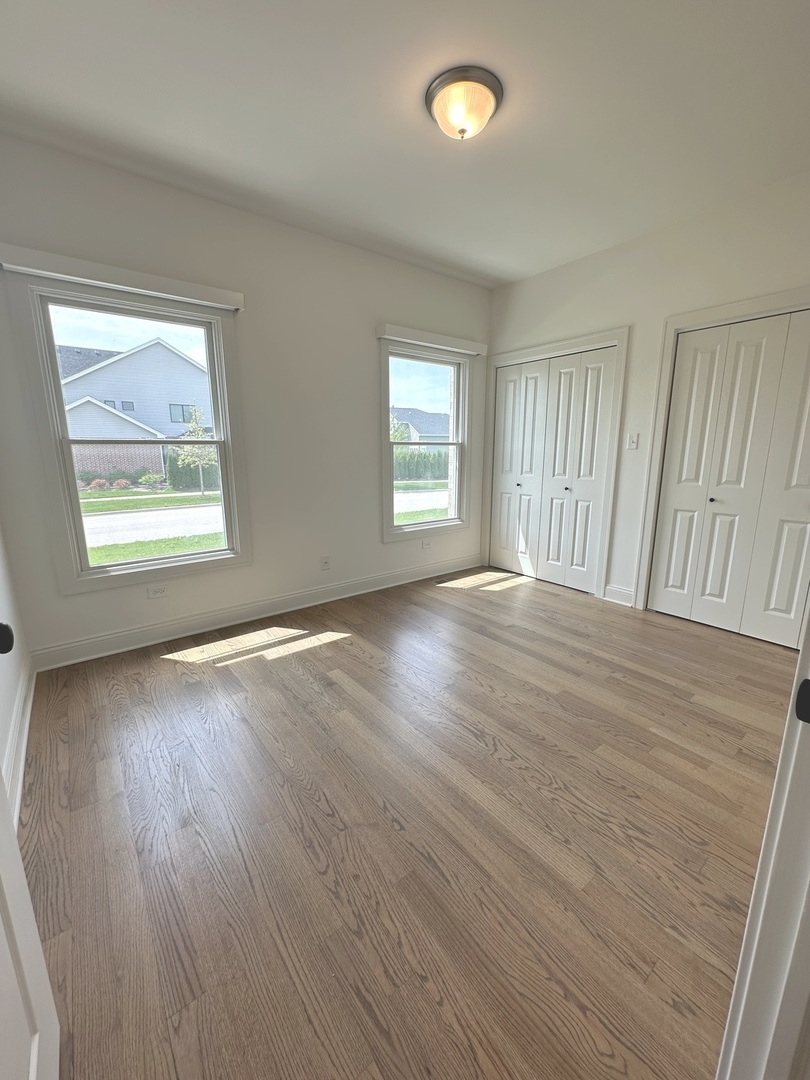 9014 Gloucester Road Woodridge, IL 60517 - Photo 22 of 30 a view of an empty room with wooden floor and a window