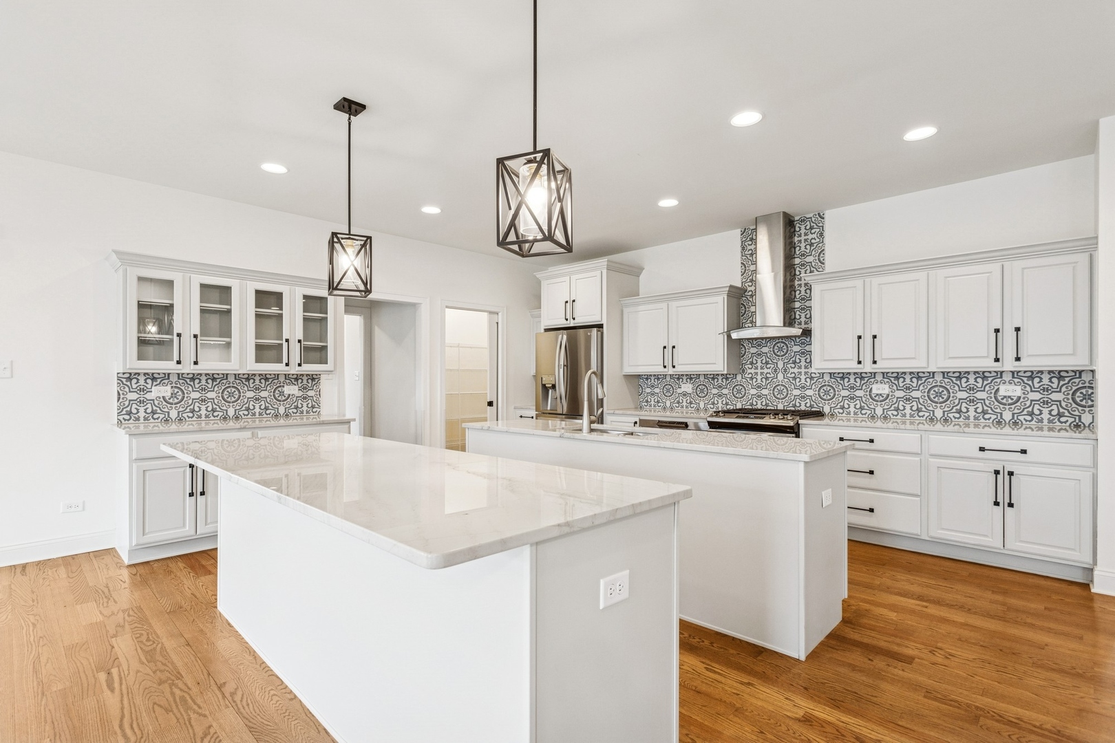 9014 Gloucester Road Woodridge, IL 60517 - Photo 6 of 30 a large kitchen with kitchen island a stove a sink a center island and wooden floor