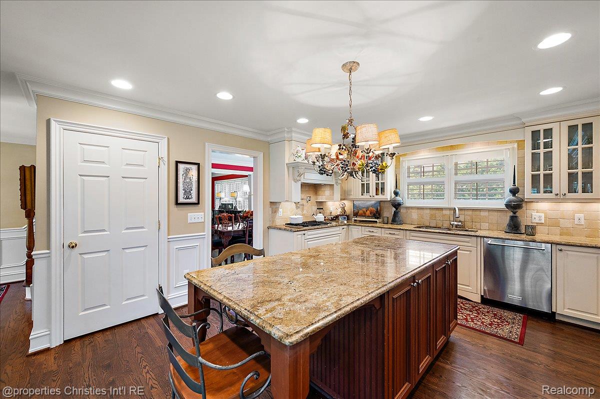 135 Clifton Road Bloomfield Hills, MI 48301 - Photo 21 of 77 Kitchen featuring a large central island with a granite countertop, light wood-finish cabinetry, stainless steel dishwasher, wood-finish flooring, and recessed lighting