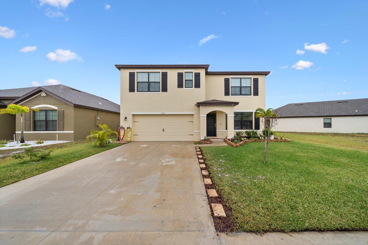 a front view of a house with a yard
