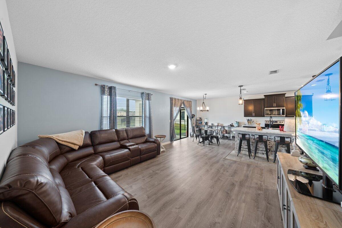 1652 Saxton Road Cocoa, FL 32926 - Photo 11 of 30 a living room with furniture and a wooden floor