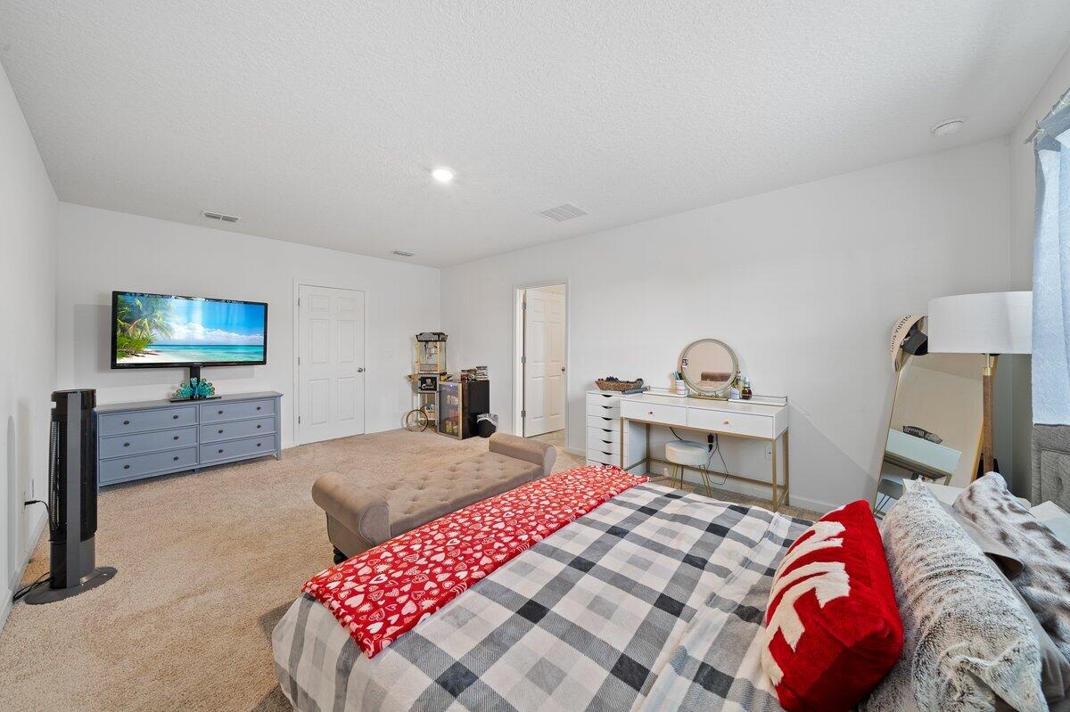 1652 Saxton Road Cocoa, FL 32926 - Photo 14 of 30 a bedroom with a bed and a flat screen tv