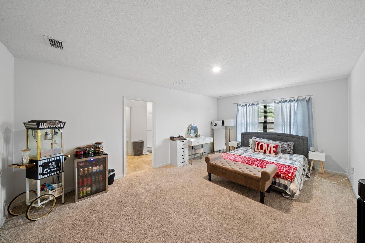 1652 Saxton Road Cocoa, FL 32926 - Photo 15 of 30 a bedroom with furniture and a large window