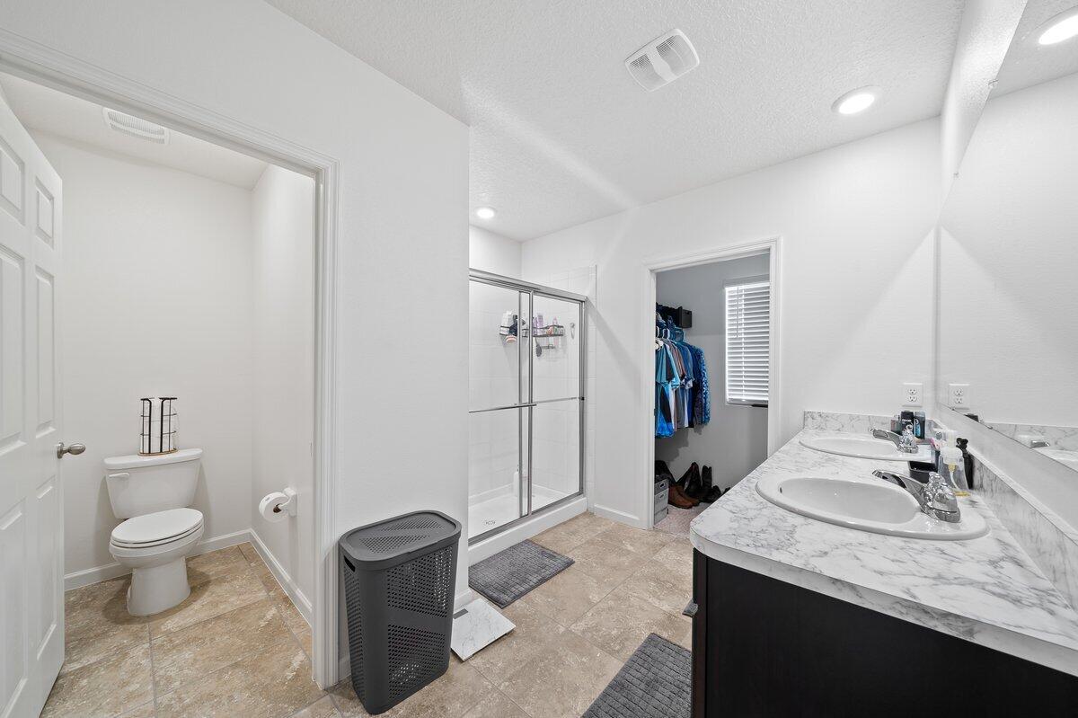 1652 Saxton Road Cocoa, FL 32926 - Photo 16 of 30 a bathroom with a granite countertop sink a toilet and a mirror