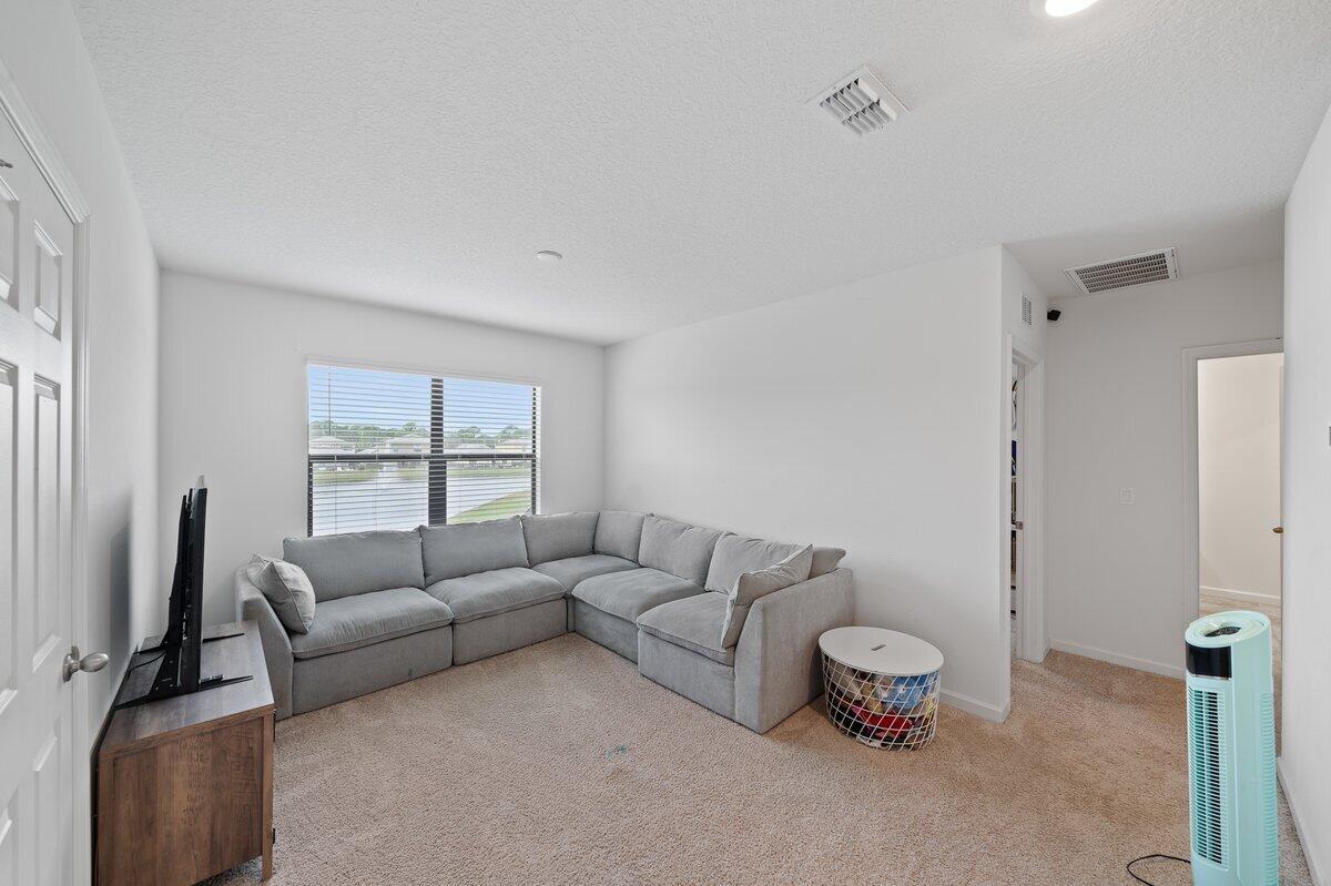 1652 Saxton Road Cocoa, FL 32926 - Photo 21 of 30 a living room with furniture a window and a flat screen tv
