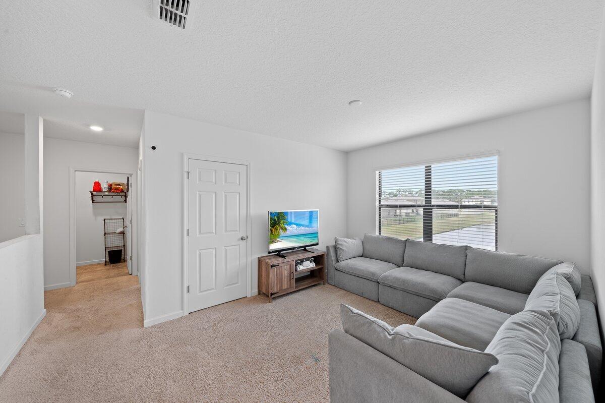 1652 Saxton Road Cocoa, FL 32926 - Photo 22 of 30 a living room with furniture and a window
