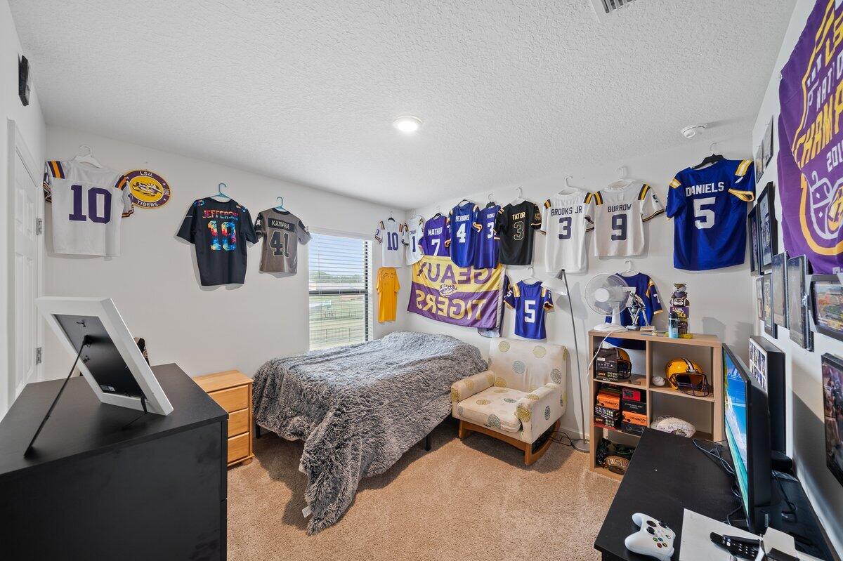 1652 Saxton Road Cocoa, FL 32926 - Photo 23 of 30 a bedroom with a bed and dresser