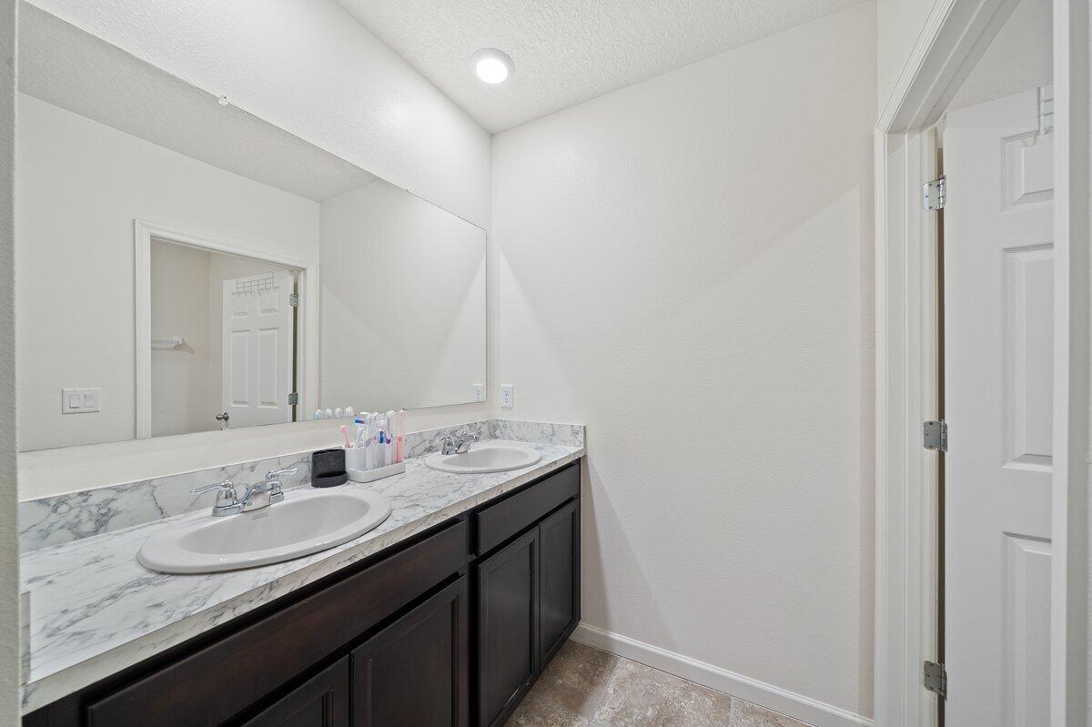 1652 Saxton Road Cocoa, FL 32926 - Photo 24 of 30 a bathroom with a granite countertop sink and a mirror