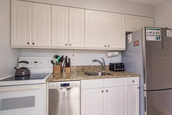 a kitchen with appliances cabinets and a counter top