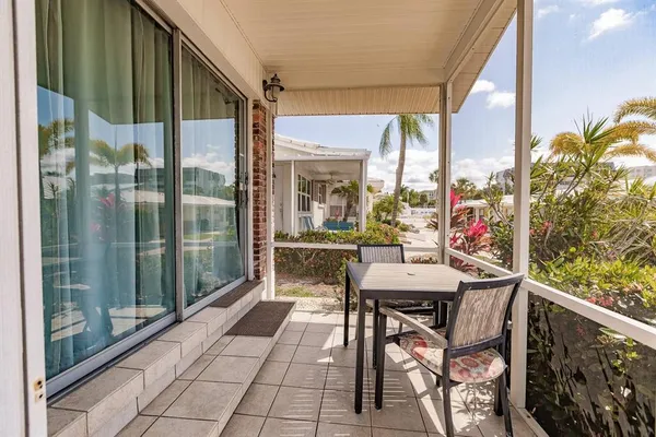 a view of a balcony dining table and chairs