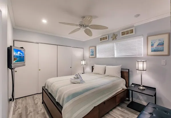 a bedroom with a bed and a chandelier