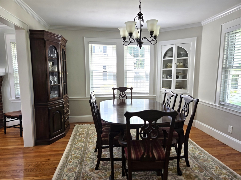25 Waldeck Road Milton, MA 02186 - Photo 6 of 34 a view of a dining room with furniture window and wooden floor