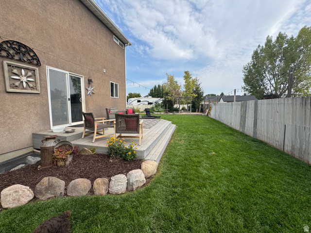 1237 South 260 West Payson, UT 84651 - Photo 17 of 81 Expansive backyard featuring a manicured lawn, a large wood-finish deck, rock-lined landscaping beds, and a full privacy fence