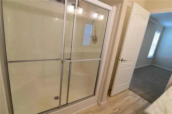 a bathroom with a glass door shower