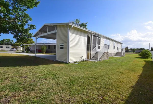 a front view of house with yard and trees