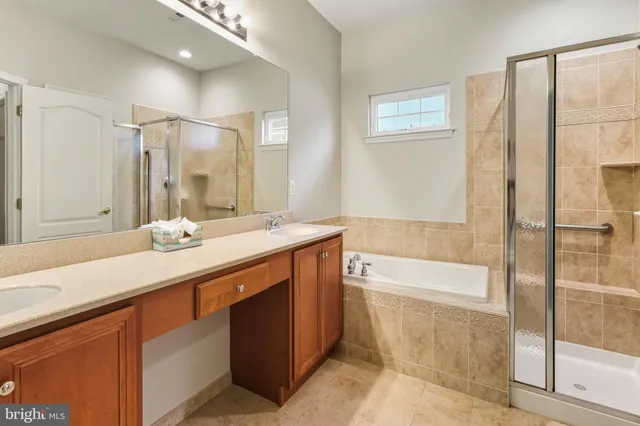 a bathroom with a tub sink and mirror