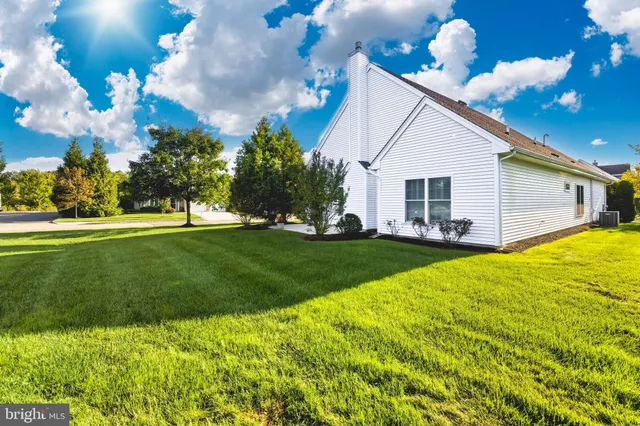 a view of a street with a house in the background