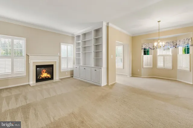 a view of an empty room with a fireplace and a window