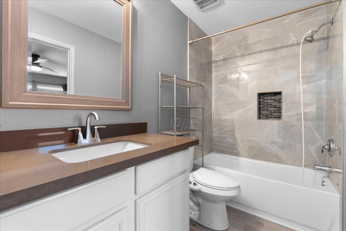 5727 Treasure Cove Road Cove, TX 77523 - Photo 9 of 20 a bathroom with a granite countertop sink toilet and shower