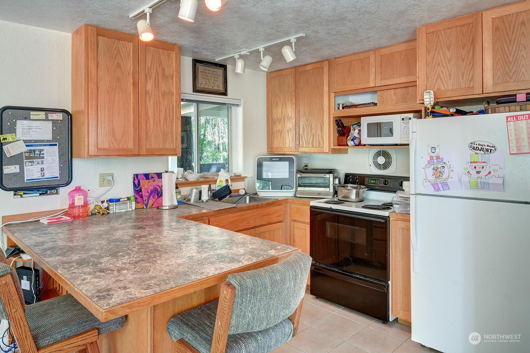 271 East Big Skookum Road Shelton, WA 98584 - Photo 16 of 24 a kitchen with stainless steel appliances granite countertop a sink stove and refrigerator