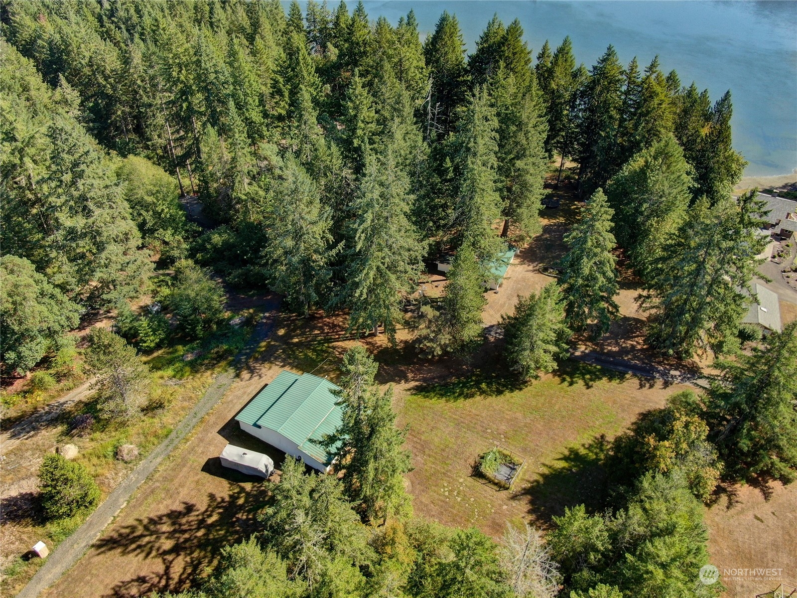 271 East Big Skookum Road Shelton, WA 98584 - Photo 23 of 24 an aerial view of a house with a yard and lake view