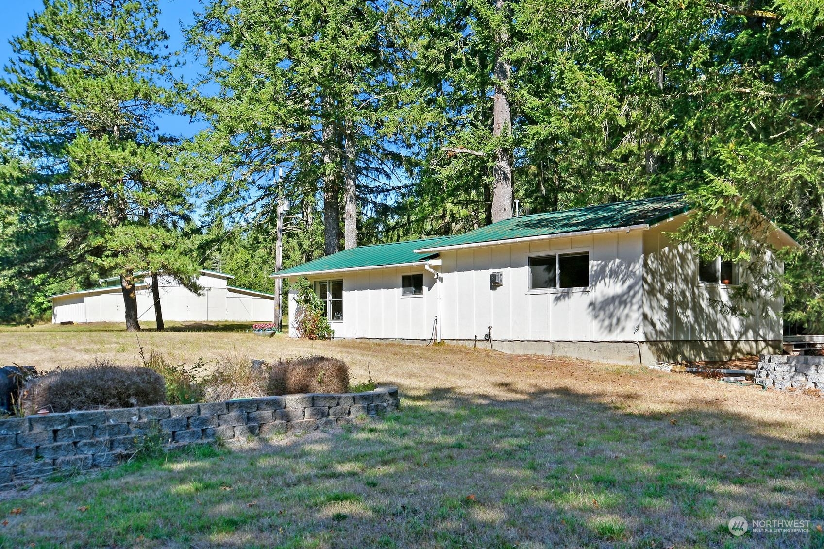 271 East Big Skookum Road Shelton, WA 98584 - Photo 4 of 24 a white house that has a tree in front of it