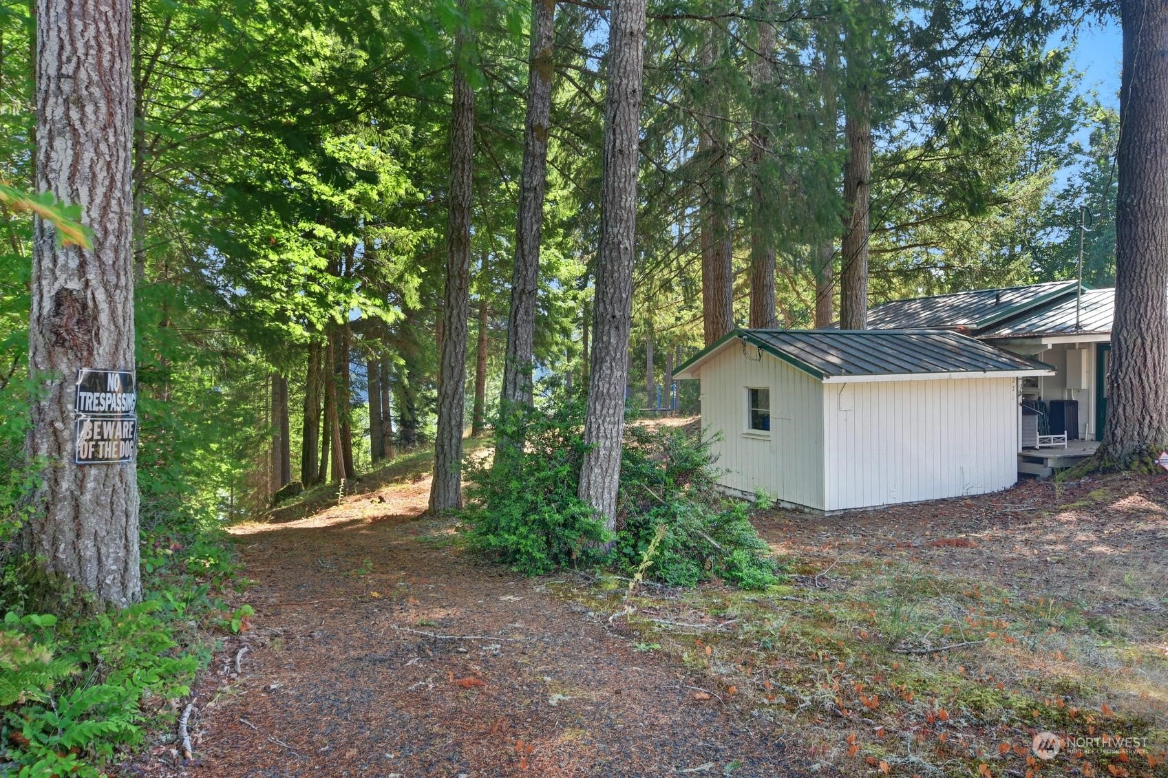 271 East Big Skookum Road Shelton, WA 98584 - Photo 10 of 24 a view of a house with large trees and a small yard