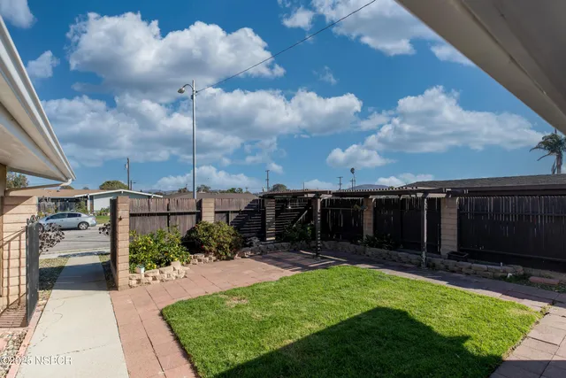 a view of a backyard with sitting area