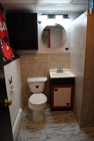 a bathroom with a sink toilet and mirror