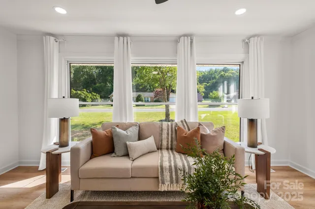 a living room with furniture and a large window