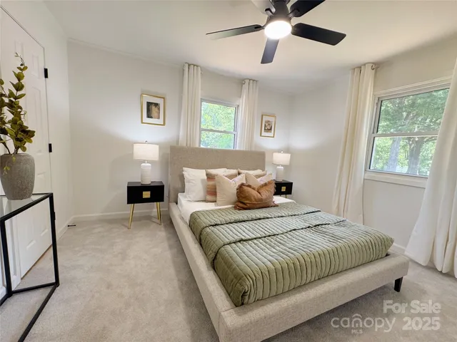 a bedroom with a large bed and a window