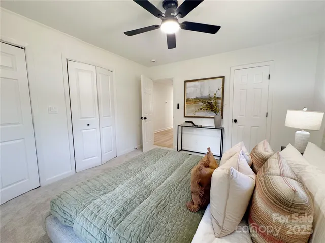 a bedroom with a bed and a painting on the wall