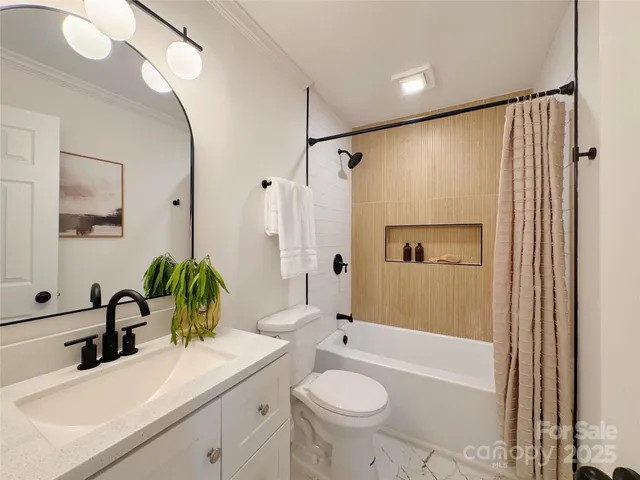 a bathroom with a sink toilet tub and shower